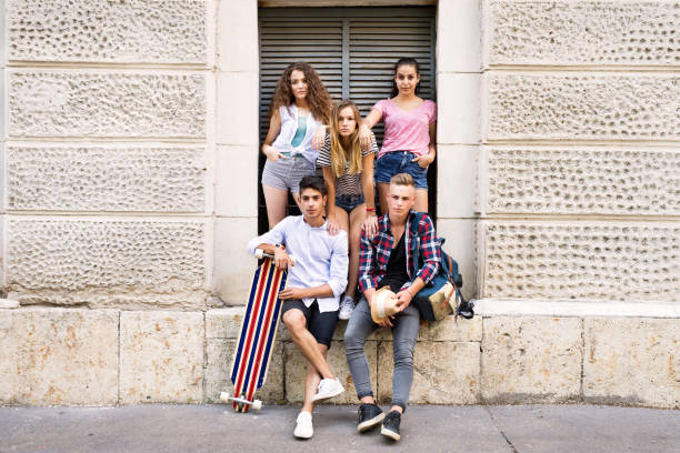 istock Attractive teenage students posing in front of university. 823776182