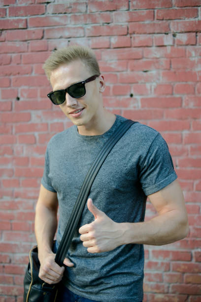 istock A young guy in glasses the brick wall 823776454