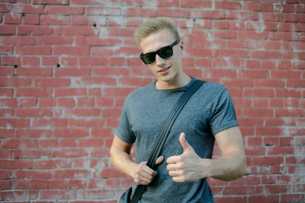 istock A young guy in glasses the brick wall 823776514