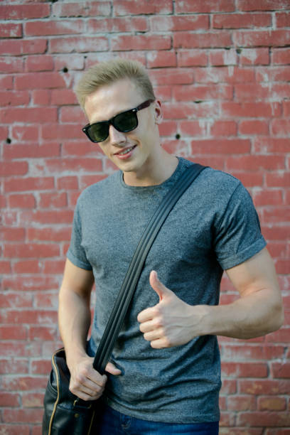 istock A young guy in glasses the brick wall 823776534