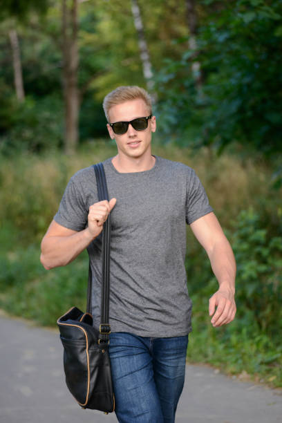istock A young guy in glasses walks in the park 823776682