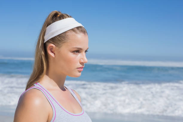 istock Sporty serious blonde standing on the beach 823781016