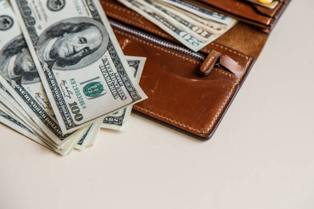 istock Dollars cash in a brown wallet 823781478