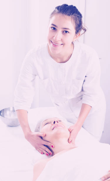 istock Mature woman having face massage 823782382
