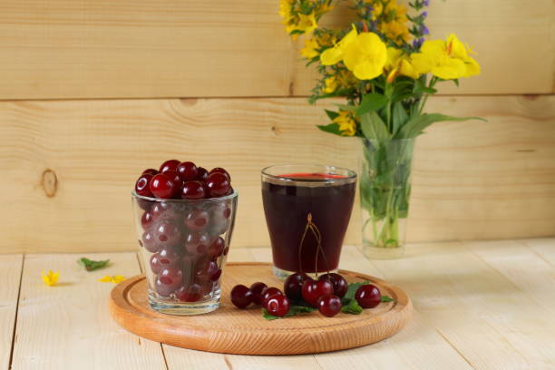 istock Fresh cherries and a glass of cherry juice. 823788020