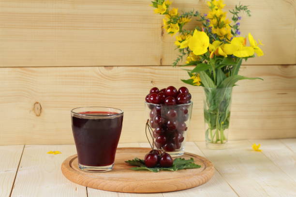 istock Fresh cherries and a glass of cherry juice. 823788128