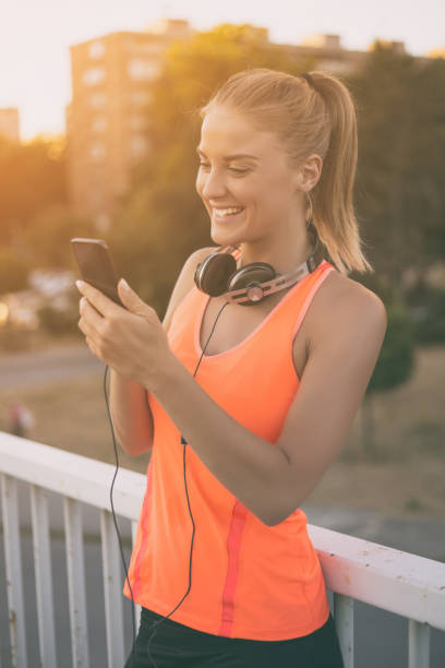 istock Sporty woman using phone 823788754