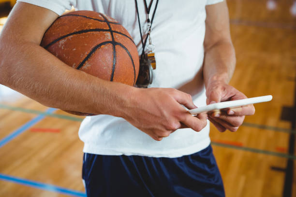 istock Close up midsection of male coach using digital tablet 823792974