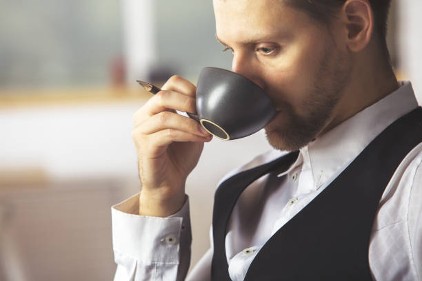 istock Handsome businessman drinking coffee at workplace 823793592
