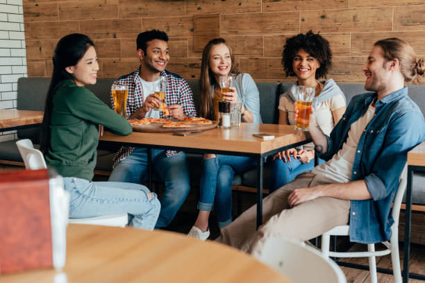istock Group of young multiethnic friends spending time in cafe 823796378