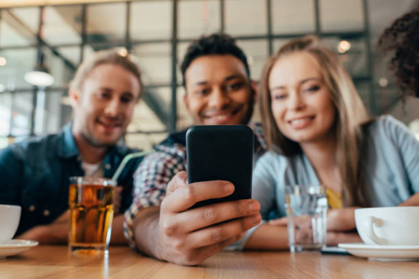 istock Young happy multiethnic friends taking selfie in cafe 823800356
