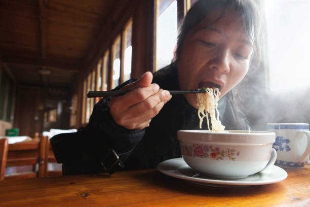 Chinese woman eating noodles