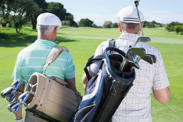 istock Golfer friends walking holding their golf bags 823814144