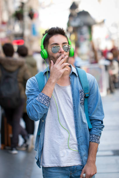 istock smoking young man with headphones and set the castle 823819186