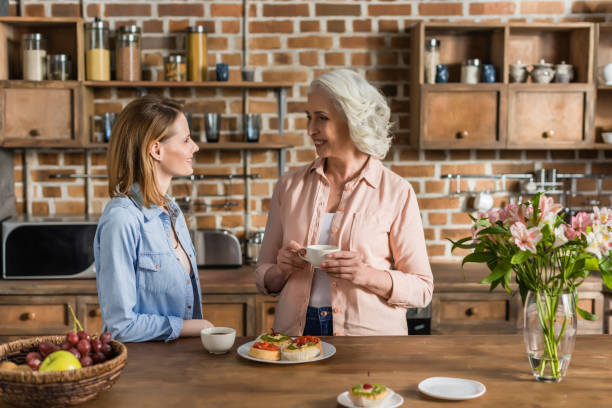 istock two women, senior and young having good time in kitchen 823819774