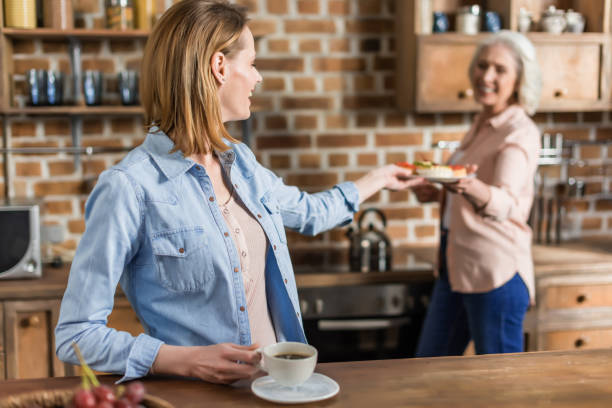 istock two women, senior and young having good time in kitchen 823823360