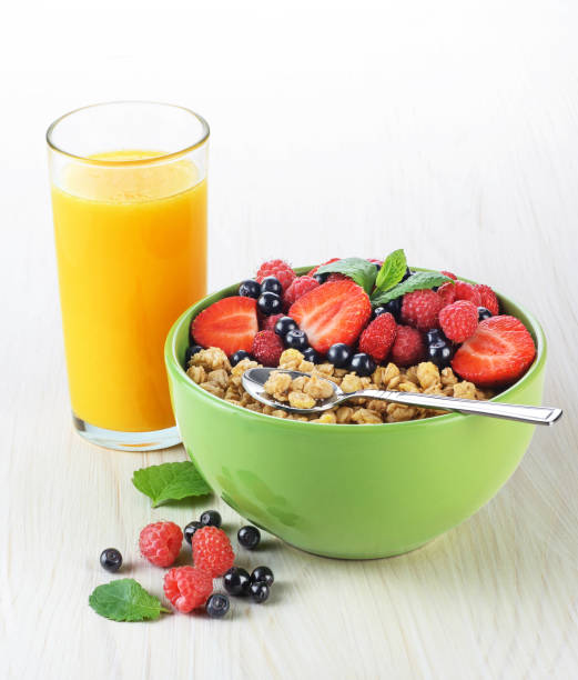 istock Muesli with fresh berries in a bowl on a light background. 823825840