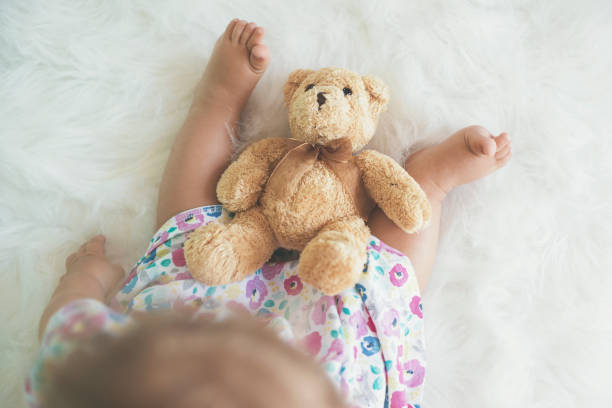 istock Top view of baby with teddy bear 823826298