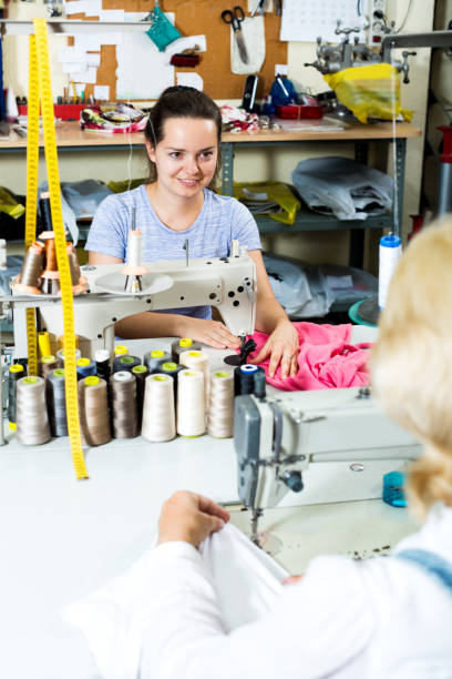 istock Two women sewing with professional equipment 823826486