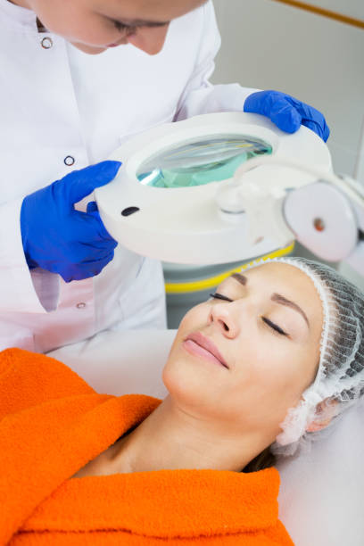 istock Cosmetologist and female client 823827364