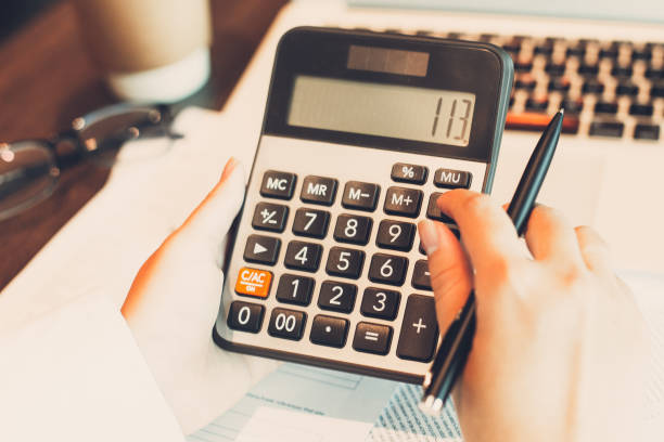istock Female accountant using calculator at laptop 823830614