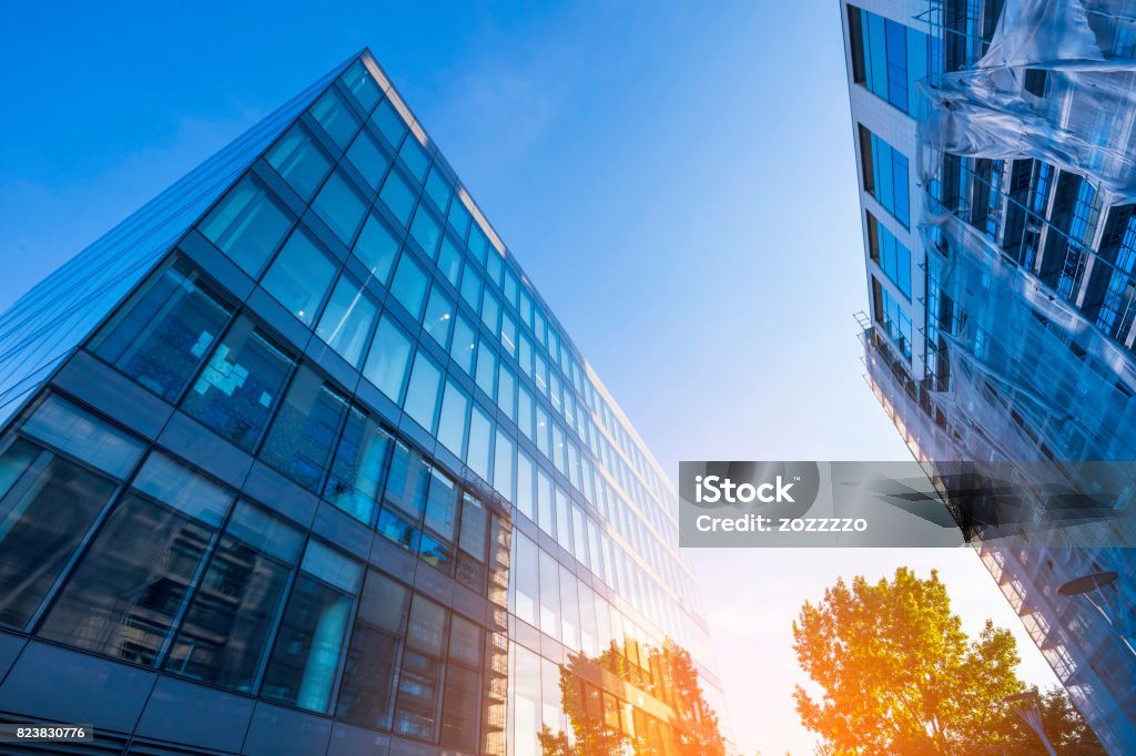 office building windows office building windows with inner artificial lamplight in blue color tone Office Building Exterior Stock Photo