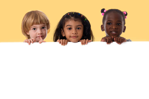 group of multiracial kids portrait with white board - preschooler childhood outdoors cheerful imagens e fotografias de stock