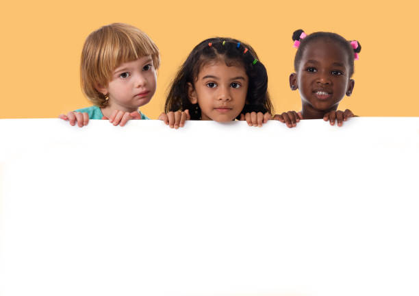 group of multiracial kids portrait with white board - preschooler childhood outdoors cheerful imagens e fotografias de stock