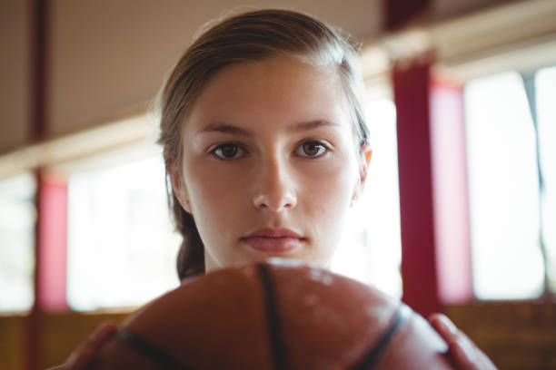 Close-up portrait of woman with basketball Close-up portrait of woman with ball in basketball court gray eyes photos stock pictures, royalty-free photos & images
