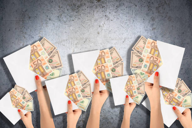 istock Hands offering money in an envelope, suggesting funding project 823839830