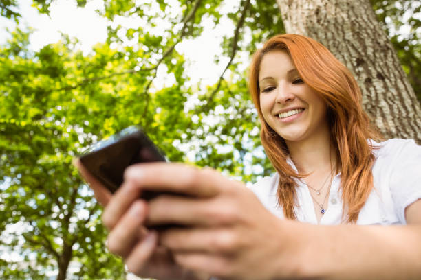 istock Pretty redhead text messaging on her phone 823840670