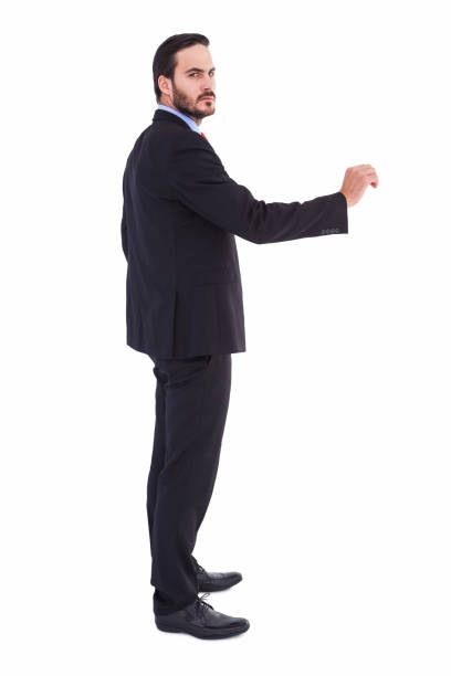 istock Serious businessman standing with arms raised 823845172