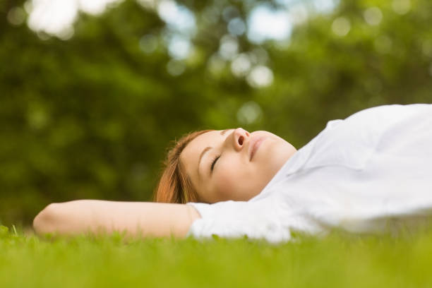 istock Pretty redhead lying with her eyes closed 823845184
