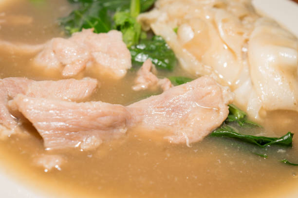 soup of pork with kale and pasta in close