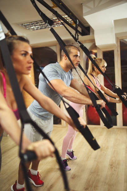 istock suspension training- people doing arm and leg exercises 823846370