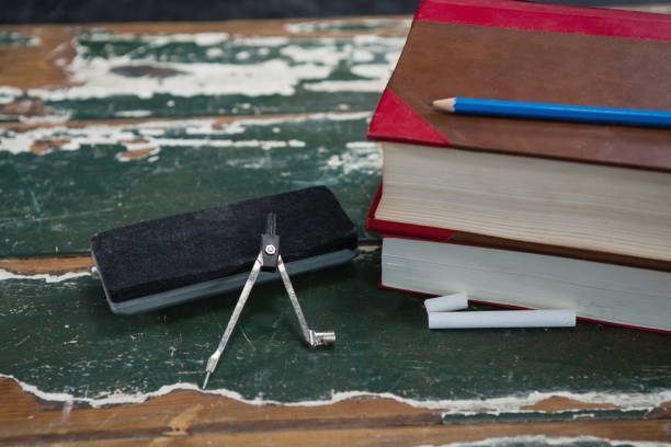 istock Books, duster and compass on wooden table 823846890