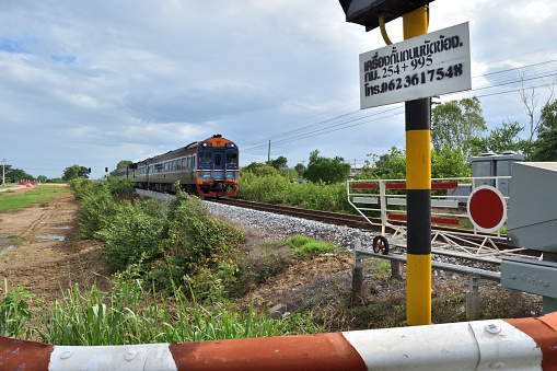 Prachuap Khiri Khan,Thailand - July 23,2017:The train moving to passing through railroad crossing