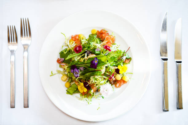 istock Green salad on a white plate 823850002