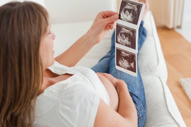 istock Charming pregnant woman looking at a sonography 823850454