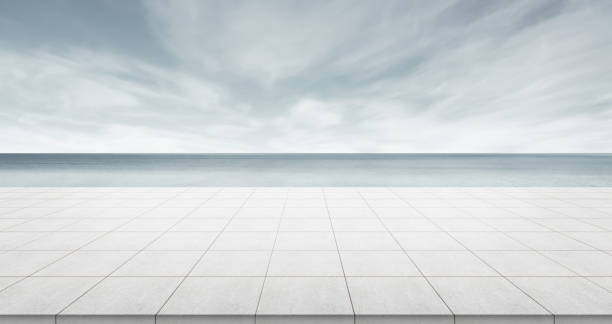 Empty concrete floor top with panoramic ocean view of morning dark sky