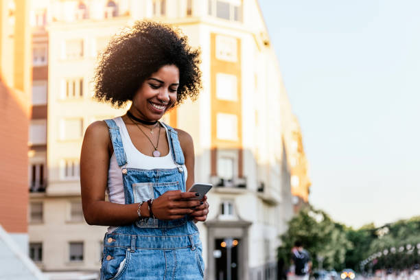 istock Beautiful woman using mobile in the Street. 823853774