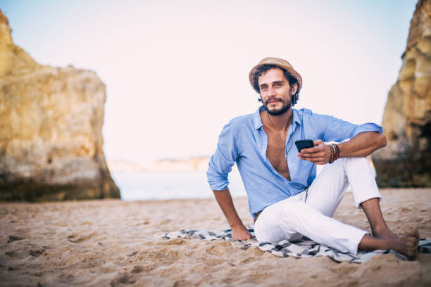 istock Listening music on the beach 823857168