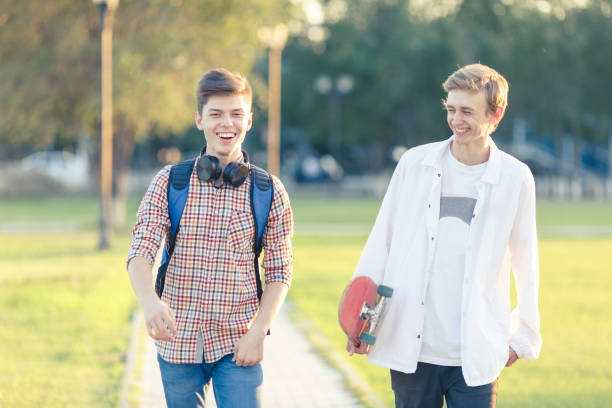 istock Two teenagers in a good mood with a skateboard 823859472
