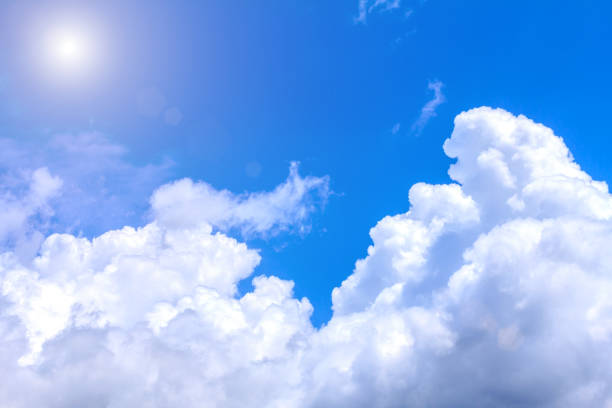 istock Blue sky background with white clouds and sunshine on sunny summer or spring day. 823859602