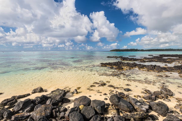 Wide-angle view of the Blue Bay Marine Park, Mauritius, Mahebourg, Indian Ocean. Stones in the foreground. Polarizer filter used.