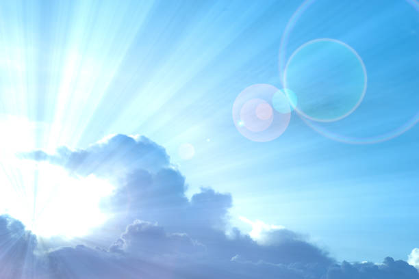 istock Abstract Background : Blue sky with sunray protruding from cloud creating lens flare. 823862066
