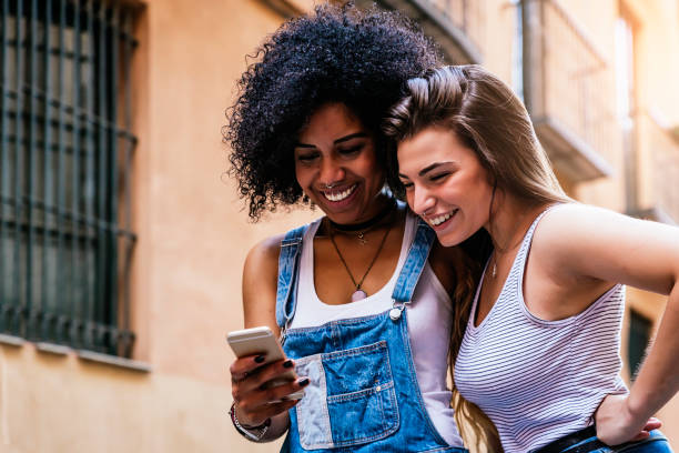 istock Beautiful women using a mobile in the Street. 823862368