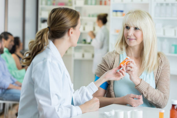 istock Pharmacist hands serious customer prescription bottle 823870520