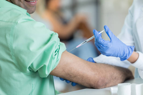istock Unrecognizable pharmacist gives customer flu shot 823870690