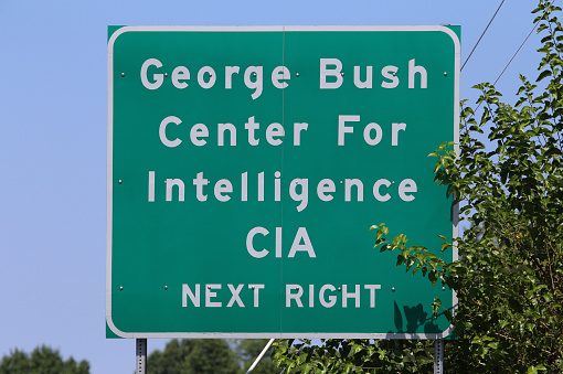 Langley, VA, USA - July 19, 2017: A road sign pointing the way to the CIA Headquarters complex. The George Bush Center for Intelligence is the headquarters of the Central Intelligence Agency.
